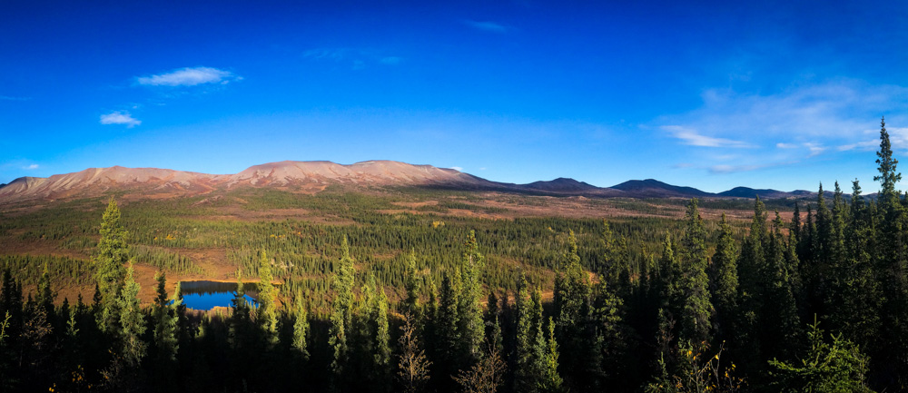 panoramic of rolling hills under blue sky