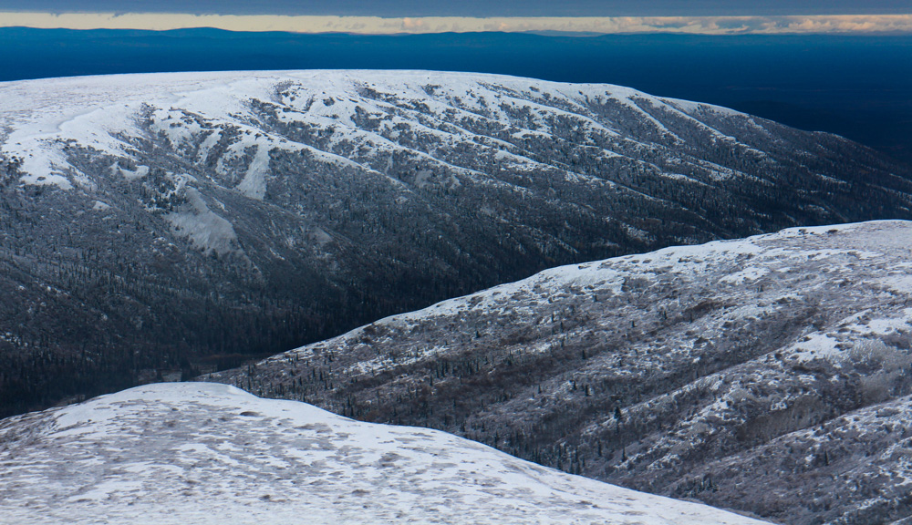 Snow-covered hilly landscape photographed from bush-plane.